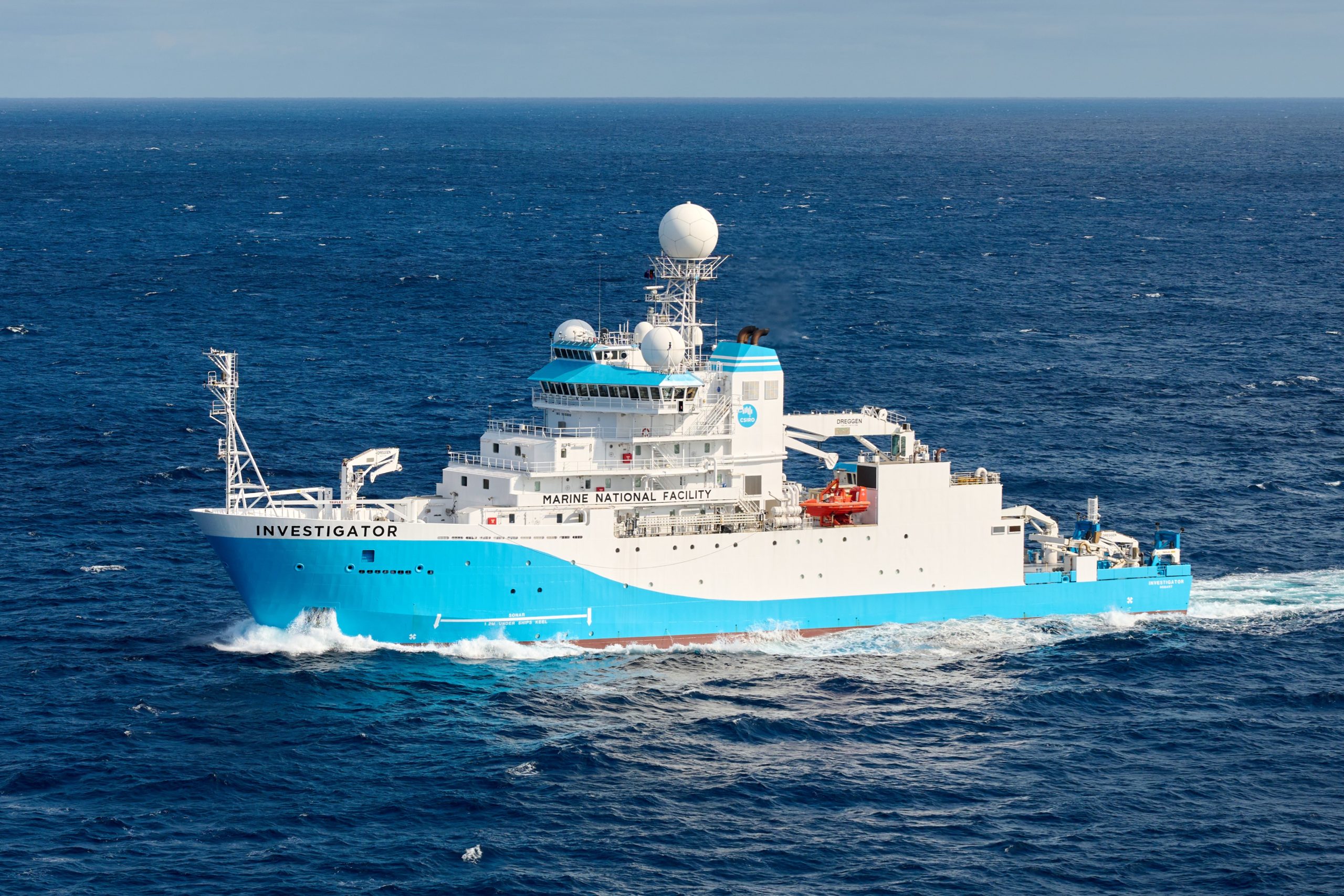 A large blue and white ship on the ocean.